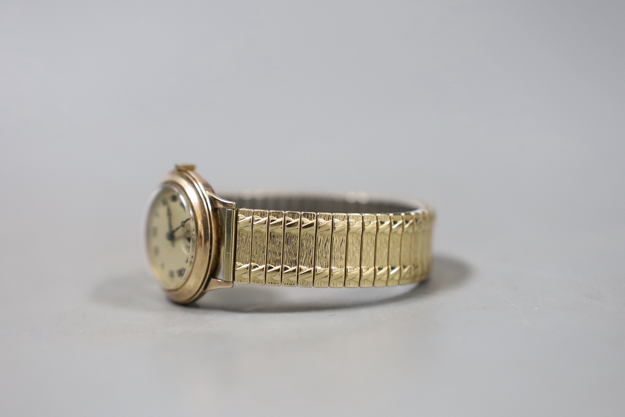 A gentleman's mid 20th century 9ct gold manual wind wrist watch, with Roman dial and subsidiary seconds, on associated flexible strap, cased diameter 29mm.